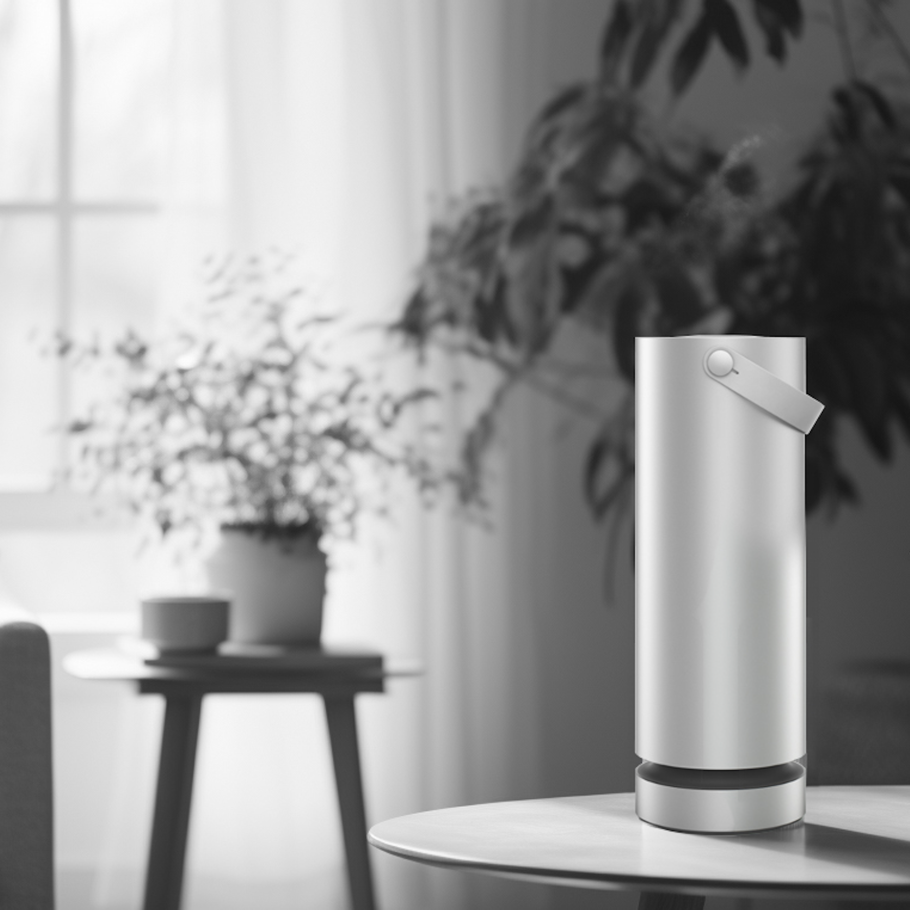 Modern air purifier on a wooden table in a bright room with plants.