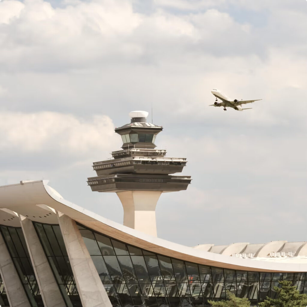An airplane flying over an airport